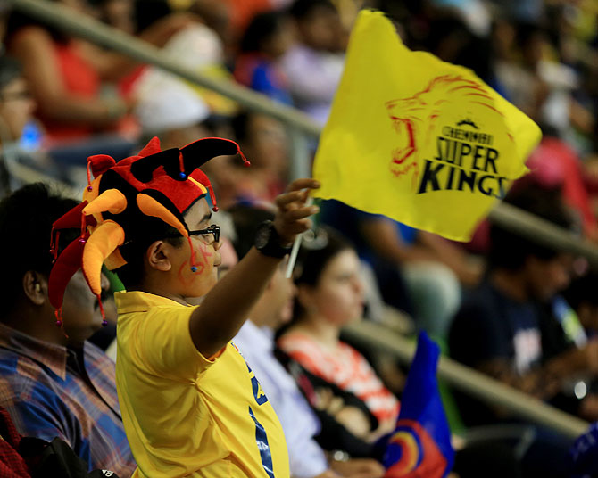 A young fan waves a Chennai Super Kings' team flag on Monday