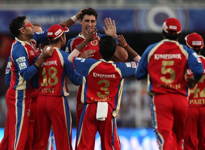 Mitchell Starc is congratulated by his Royal Challenger Bangalore teammates after dismissing Gautam Gambhir