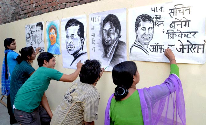   Artists make paintings of Sachin Tendulkar to wish him on the eve of his birthday in Moradabad, on Wednesday.