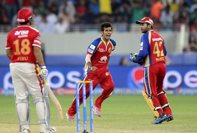 Yuzvendra Chahal (centre) celebrates after taking the wicket of Virender Sehwag