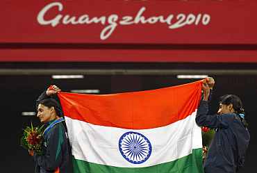 Members of India's women's 4x400m relay team celebrate their win at the 16th Asian Games in Guangzhou