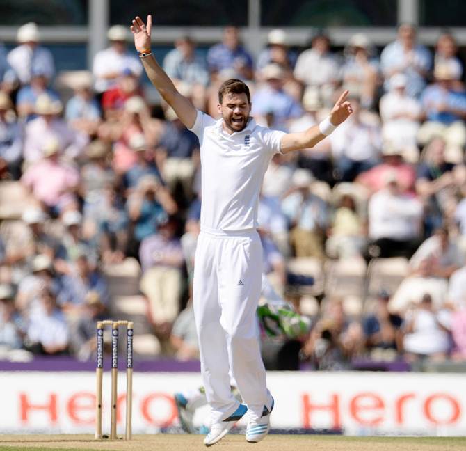 England's James Anderson (right) celebrates after taking a wicket