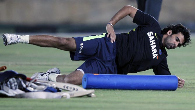 Zaheer Khan stretches during a training session