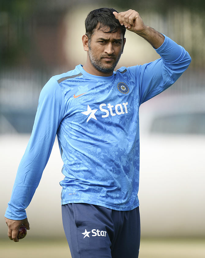 India's Mahendra Singh Dhoni looks on during a training session before the fourth cricket Test match against England at the Old Trafford cricket ground, Manchester on Tuesday