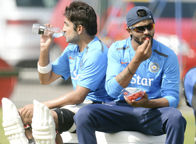 India's Ravindra Jadeja (right) eats a strawberry as he sits with team-mate Gautam Gambhir during a training session at the Old Trafford cricket ground, Manchester on Tuesday
