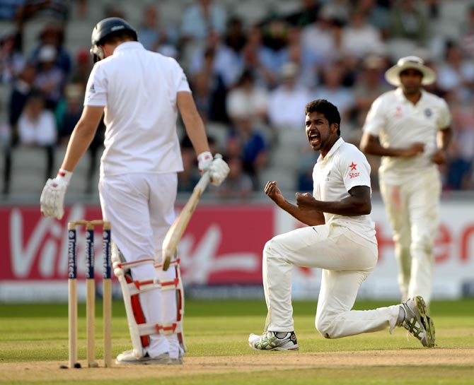Varun Aaron (right) of India celebrates dismissing Gary Ballance