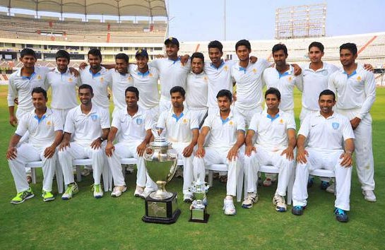 Karnataka's players pose after winning the Ranji Trophy last season