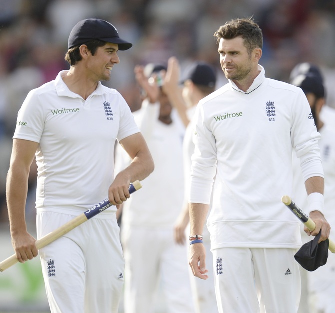 Captain Alastair Cook (left) and James Anderson leave the field after England beat India in the fourth Test at Old Trafford cricket ground in Manchester on Saturday