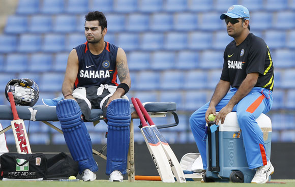 India's captain Mahendra Singh Dhoni, right, and Virat Kohli look on during a practice session