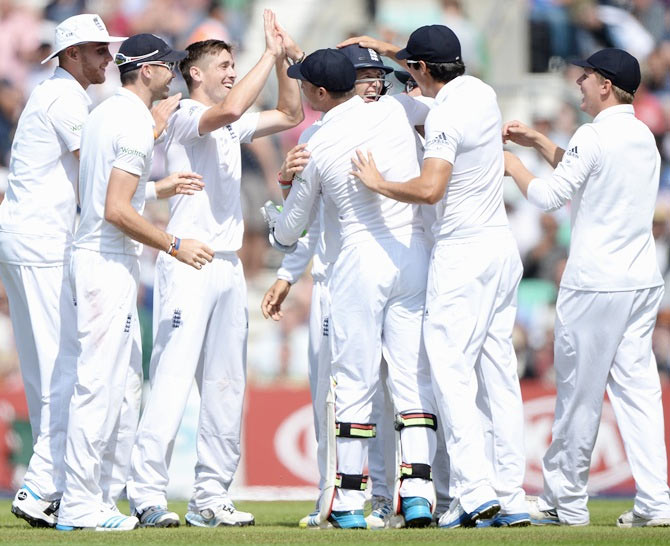 Chris Woakes of England celebrates the wicket of Murali Vijay with teammates