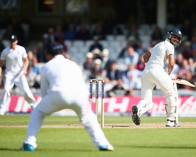Virat Kohli of India looks back as he is caught out by Alastair Cook of England