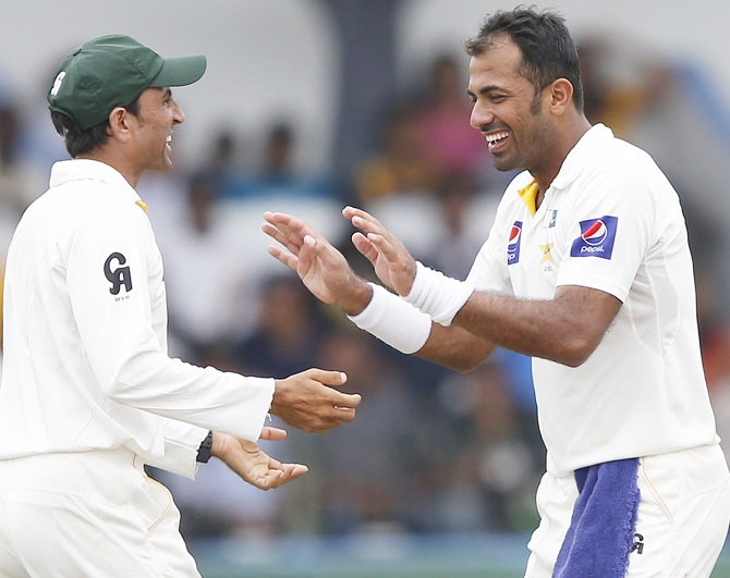 Pakistan's Wahab Riaz, right, celebrates with teammate Younis Khan after taking the wicket of Sri Lanka's Rangana Herath (not pictured)