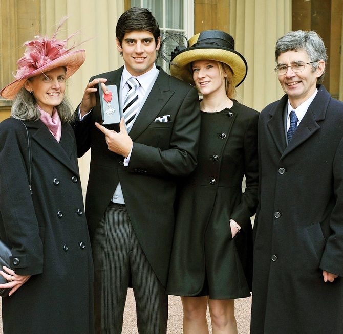 England cricketer Alastair Cook stands with his wife Alice Hunt,second right, and parents Stephanie and Graham as he displays his Member of the Most Excellent Order of the British Empire (MBE) medal