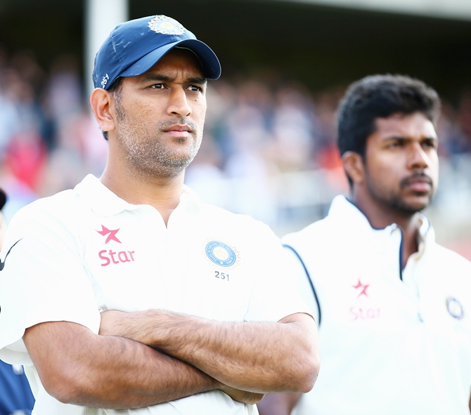 India captain Mahendra Singh Dhoni, left and Varun Aaron after India lost the series.