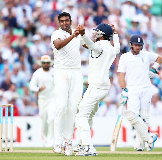 Ravichandran Ashwin of India celebrates with his team-mates after taking the wicket of Gary Ballance of England