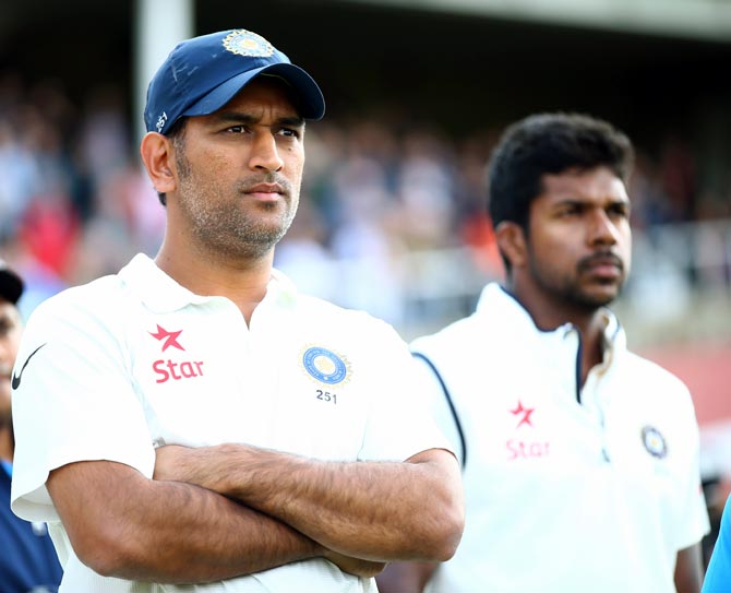 Mahendra Singh Dhoni and pacer Varun Aaron look on after India lost the fifth Test at The Oval