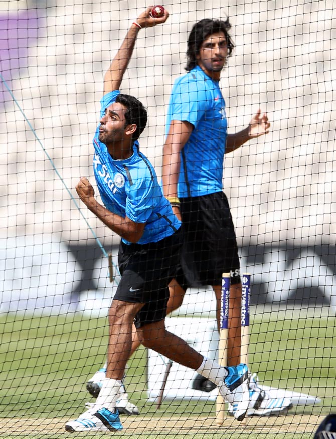 Bhuvneshwar Kumar (left) bowls in the nets as team mate Ishant Sharma looks on
