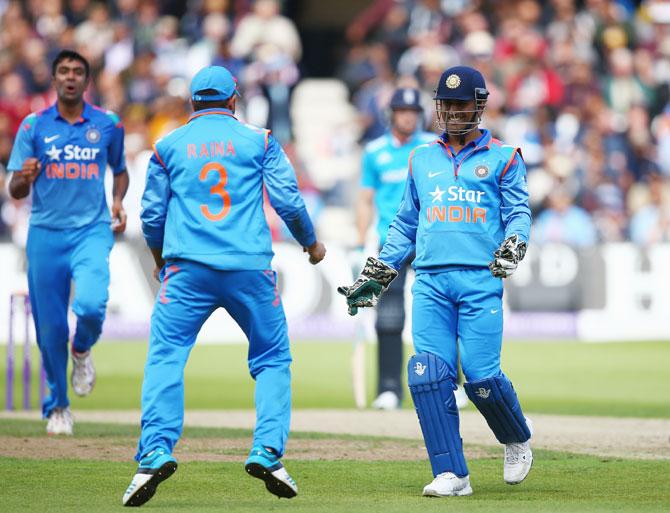 Mahendra Singh Dhoni and Suresh Raina of India celebrate the dismissal of England's   Ben Stokes, off Ravichandran Ashwin 