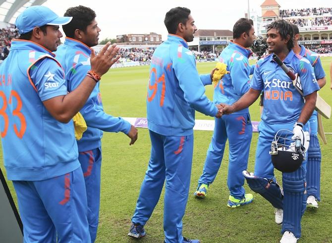 Ambati Rayudu, right, of India is congratulated by team mates