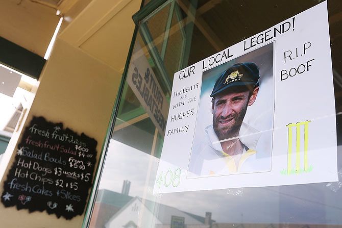 A tribute to Phillip Hughes is left outside a shop front in Macksville on Tuesday