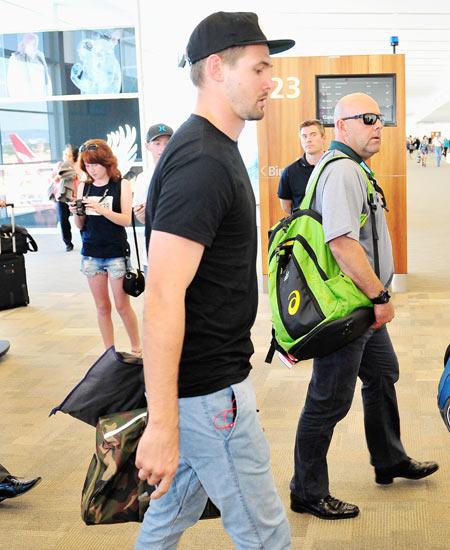 Australia's Kane Richardson (left) and coach Darren Lehmann arrive at the Adelaide Airport on Thursday