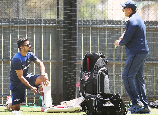 India's Virat Kohli talks to BCCI's director of cricket Ravi Shastri during an India training session at Adelaide Oval on Monday