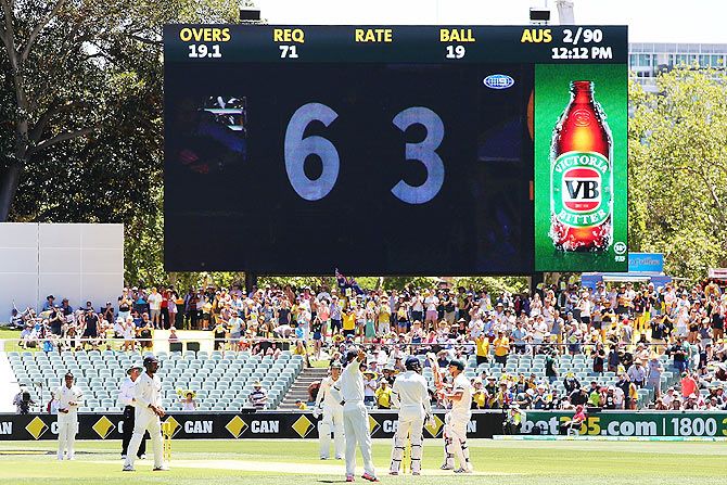David Warner (right) pays tribute to the late Phillip Hughes after reaching a score of 63