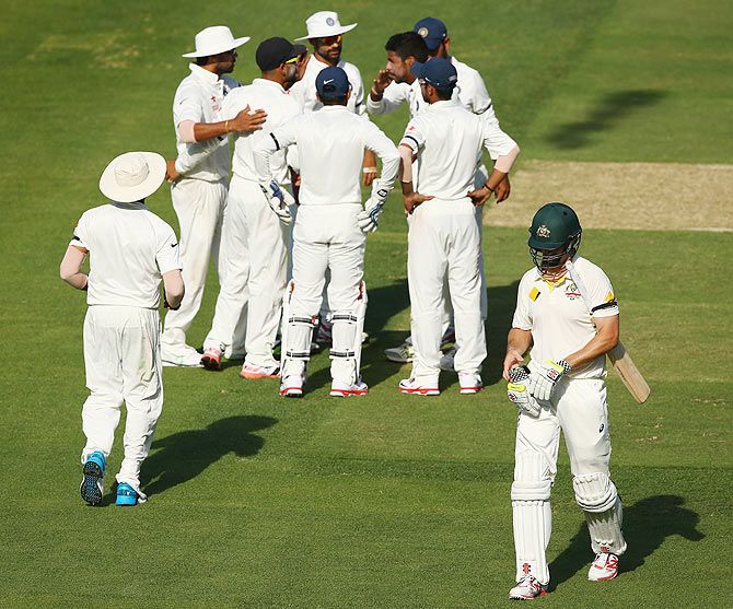 India's players celebrate the dismissal of Australia's Mitchell Marsh on Day 1 of the first Test at the Adelaide Oval on Tuesday