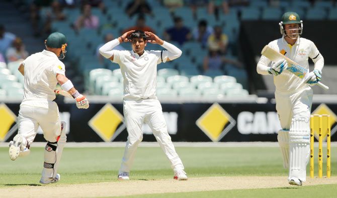 Karn Sharma of India reacts as Australian players steal a run off his bowling on Tuesday