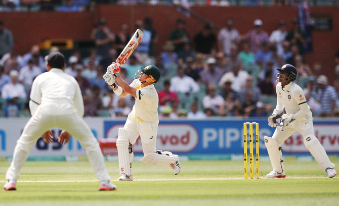 David Warner skies the ball and is caught by Ishant Sharma off the bowling of Karn Sharma