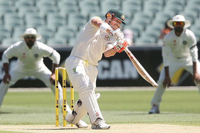 David Warner of Australia scores a boundary off Mohammed Shami of India on Day One of the first Test at the Adelaide Oval on Tuesday