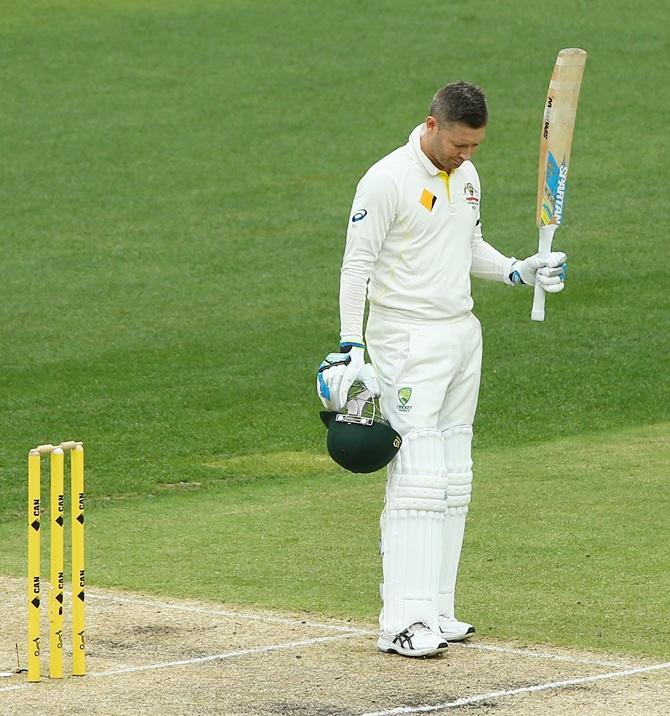 Michael Clarke of Australia raises his bat