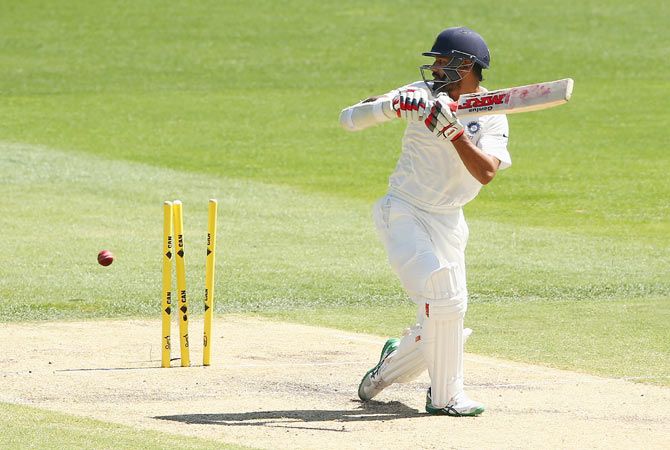 Shikhar Dhawan of India is bowled out by Ryan Harris of Australia