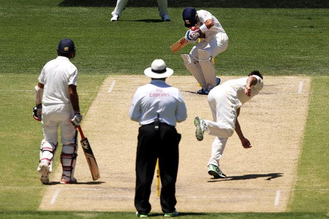 Virat Kohli is hit on the helmet by a bouncer from Mitchell Johnson
