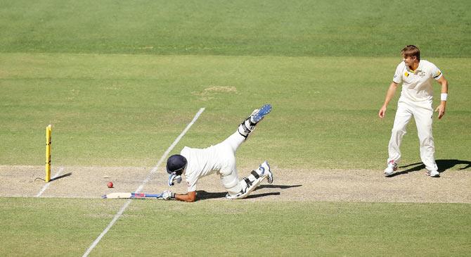 Shane Watson looks on as Rohit Sharma makes his ground