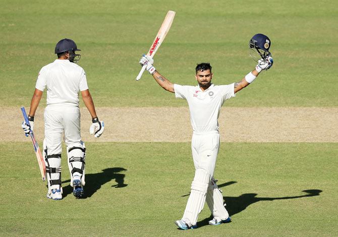 India captain Virat Kohli celebrates after completing his century on Day 3 of the first Test against Australia at the Adelaide Oval on Thursday