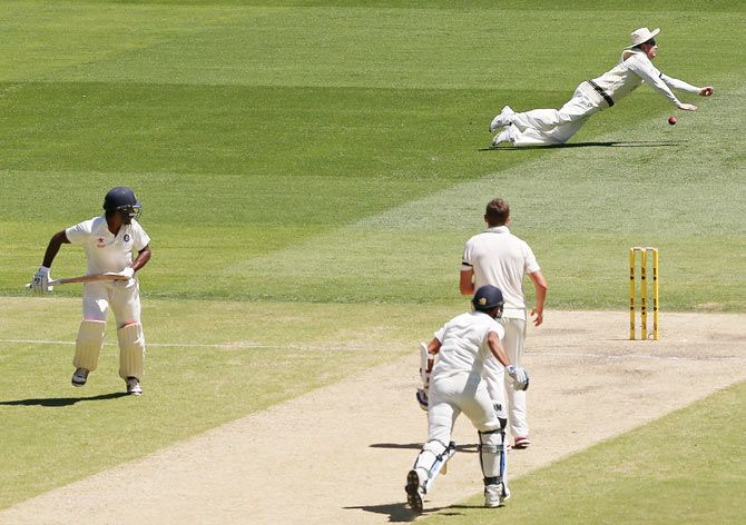 Michael Clarke dives full length as he attempts to take a catch to dismiss Mohammed Shami