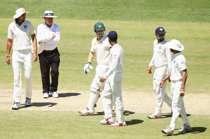 Shane Watson of Australia exchanges words with Shikhar Dhawan as other players watch