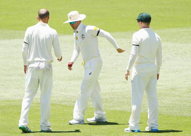 Michael Clarke of Australia tries to find his feet after pulling his hamstring while fielding on Saturday