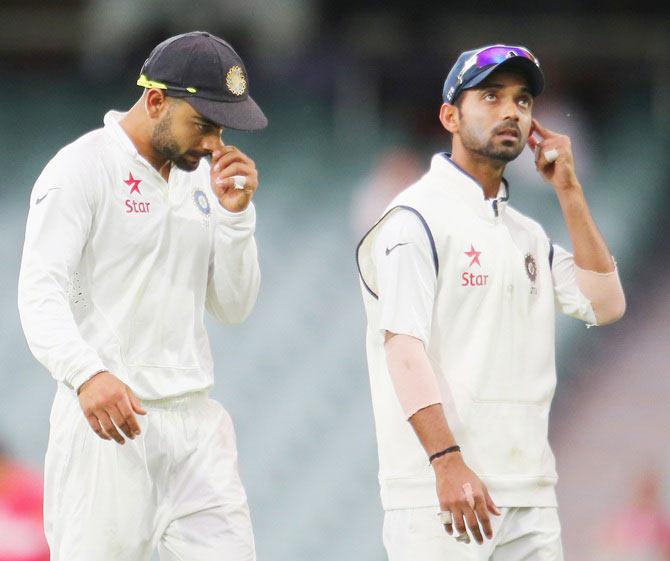 Virat Kohli and Ajinkya Rahane of India leave the field at the conclusion of day two of the First Test against Australia at Adelaide Oval