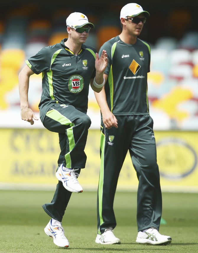 Australia captain Steven Smith and bowler Josh Hazlewood warm up during a nets Session at The Gabba on Tuesday