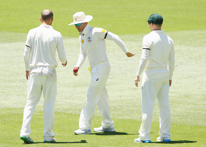 Michael Clarke of Australia tries to find his feet after pulling his hamstring while fielding during the first Test in Adelaide