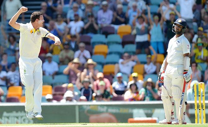 Josh Hazlewood of Australia celebrates taking the wicket of Cheteshwar Pujara at the Gabba on Wednesday