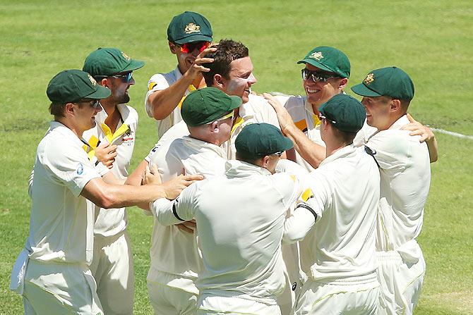 Josh Hazlewood of Australia celebrates with teammates after dismissing Cheteshwar Pujara 