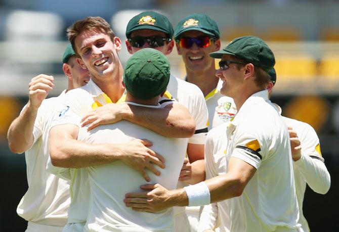 Mitchell Marsh celebrates with teammates after dismissing Shikhar Dhawan