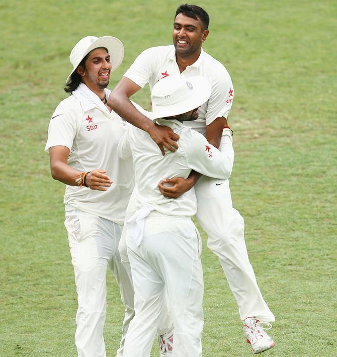 Ravichandran Ashwin of India celebrates with team mate Shikhar Dhawan