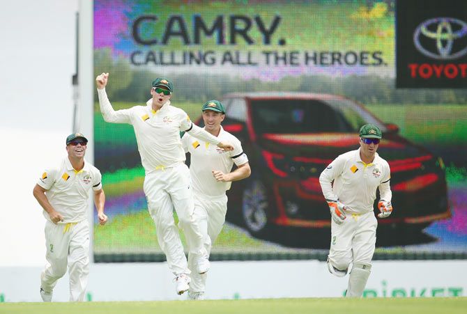 Australian captain Steve Smith celebrates after catching out Rohit Sharma 