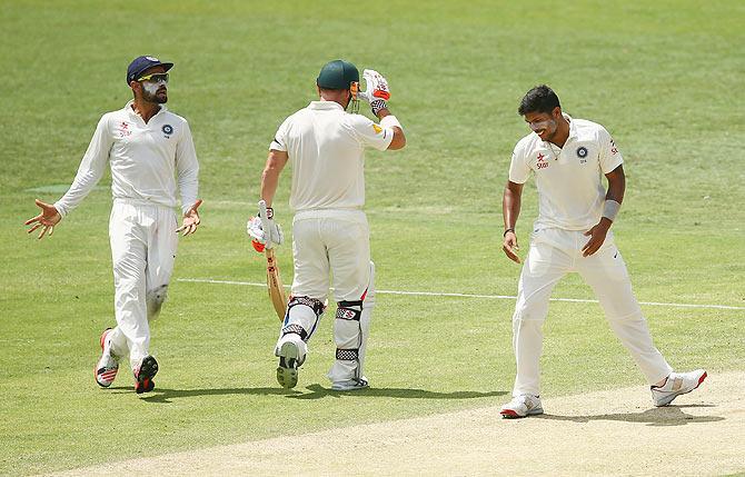 Umesh Yadav celebrates after dismissing David Warner