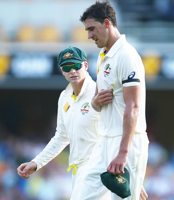 Australian captain Steve Smith checks on team mate Mitchell Starc