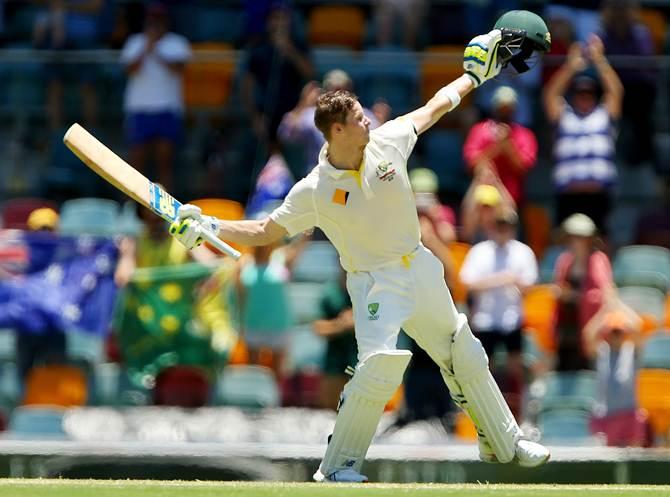 Australia captain Steven Smith celebrates after scoring a century on Day 3 in the second Test against India at the Gabba in Brisbane on 